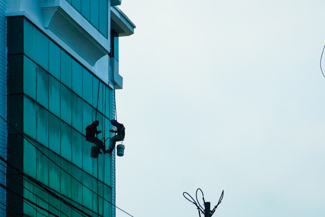 services-01 two-window-cleaners-work-on-a-tall-building-bxsbr9a-z7e