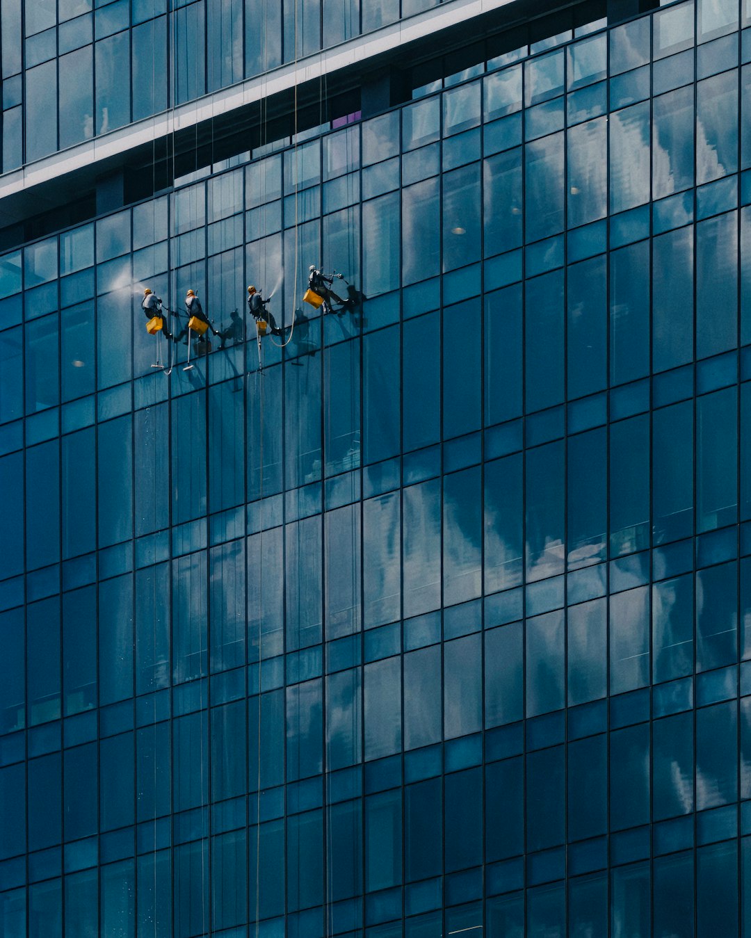 home-img Window washers cleaning the glass windows of TRX tower in Malaysia